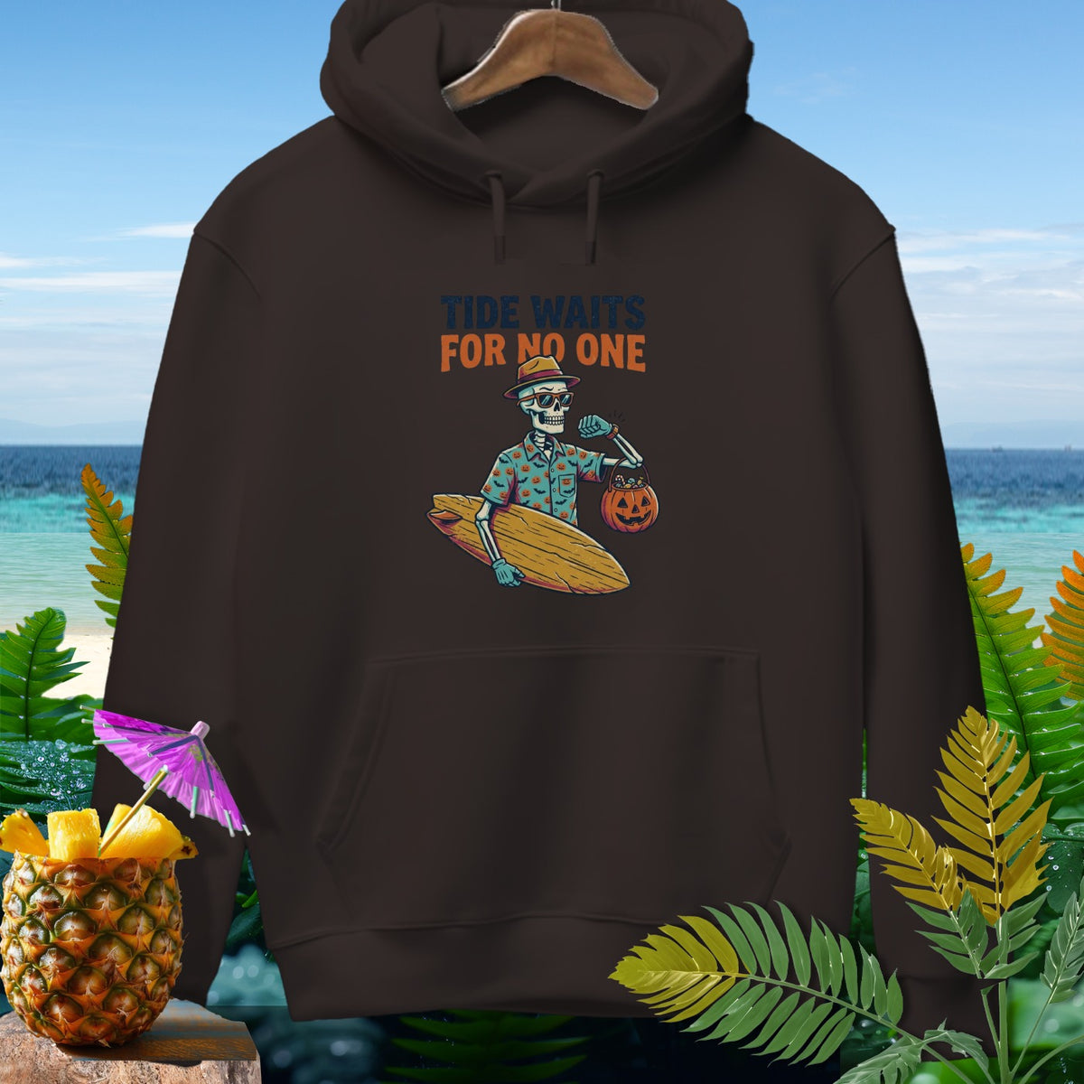 Brown hoodie with skeleton surfer graphic and text "Tide Waits For No One".