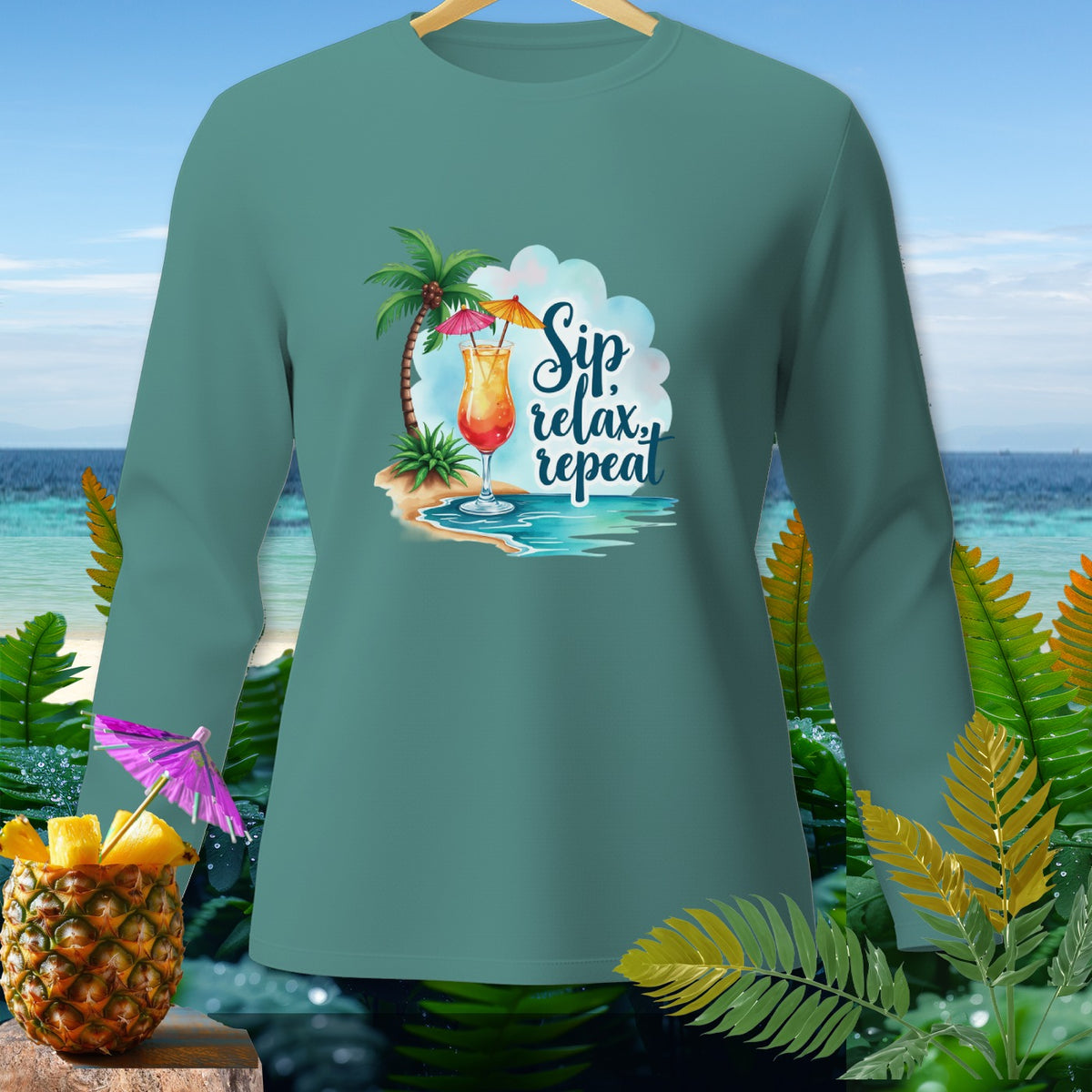 Teal long sleeve shirt with tropical drink and "Sip relax repeat" text.
