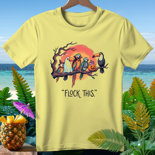 Yellow t-shirt with parrots, skeleton, pumpkin, and toucan on a branch with text "FLOCK THIS."
