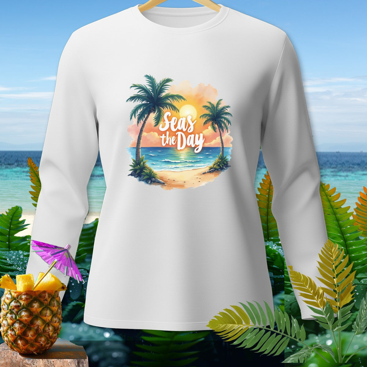 White long-sleeve shirt with a tropical beach graphic and "Seas the Day" text.