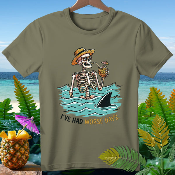 Skeleton in water drinking from pineapple with shark fin, text says "I'VE HAD WORSE DAYS."