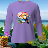 Lavender long-sleeve shirt with a watercolor toucan on a branch at sunset design.