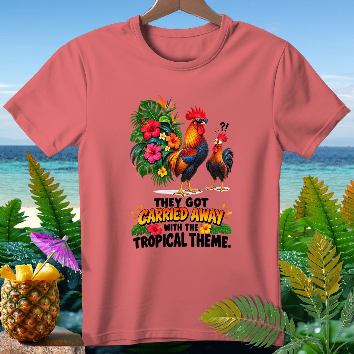 T-shirt with two roosters and tropical flowers, text reads "They got carried away with the tropical theme."