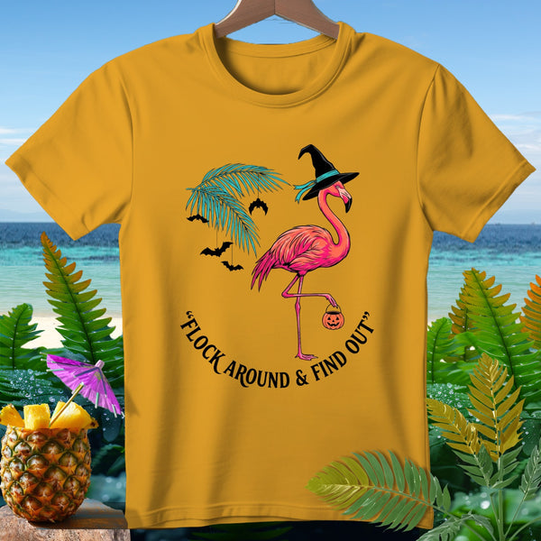 Yellow t-shirt with flamingo in witch hat holding pumpkin, text reads "Flock Around & Find Out".