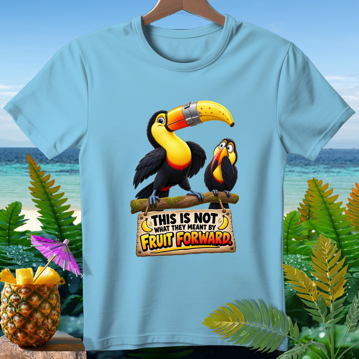 Light blue t-shirt with two toucans and text "This is not what they meant by fruit forward."