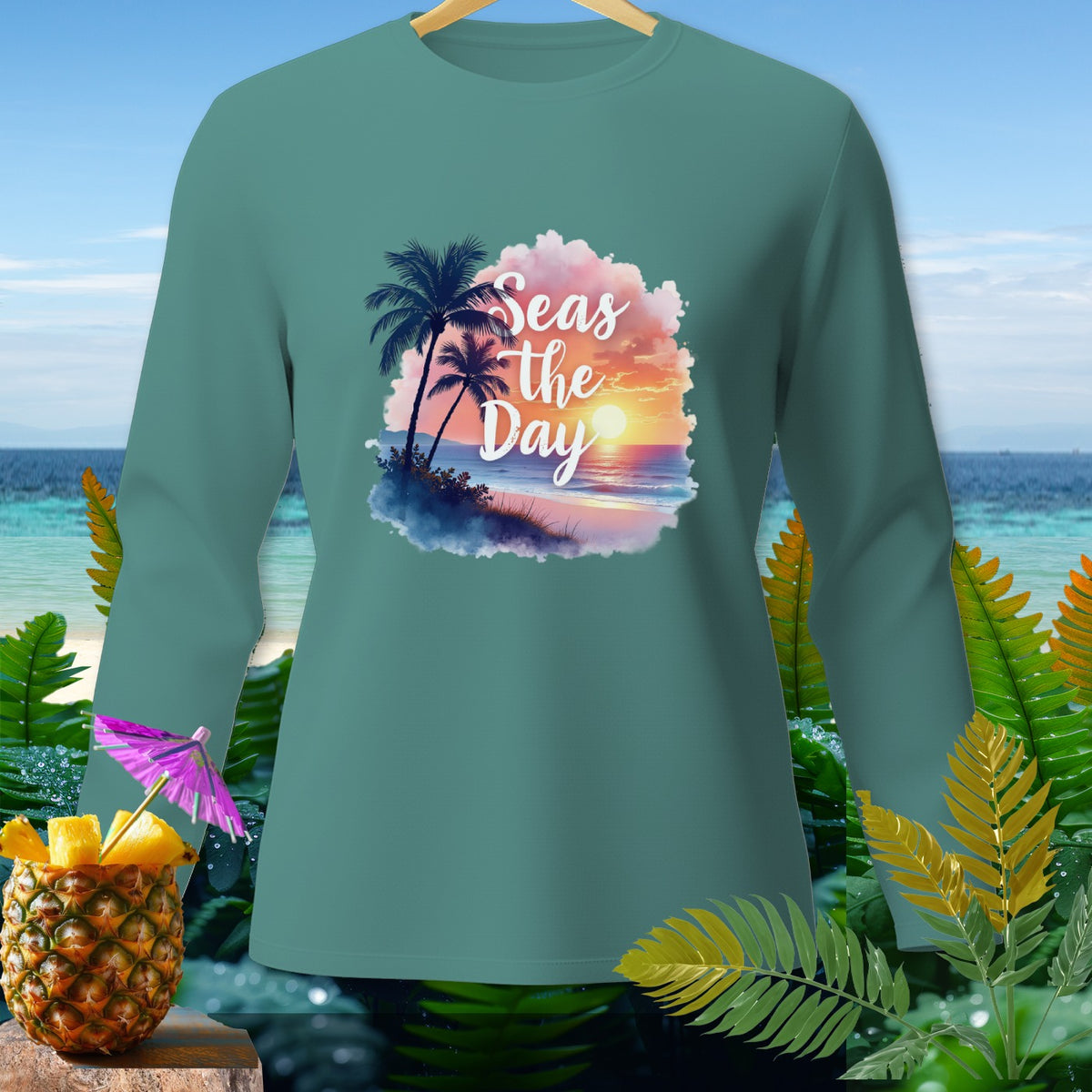 Teal long-sleeve shirt with "Seas the Day" beach sunset graphic.