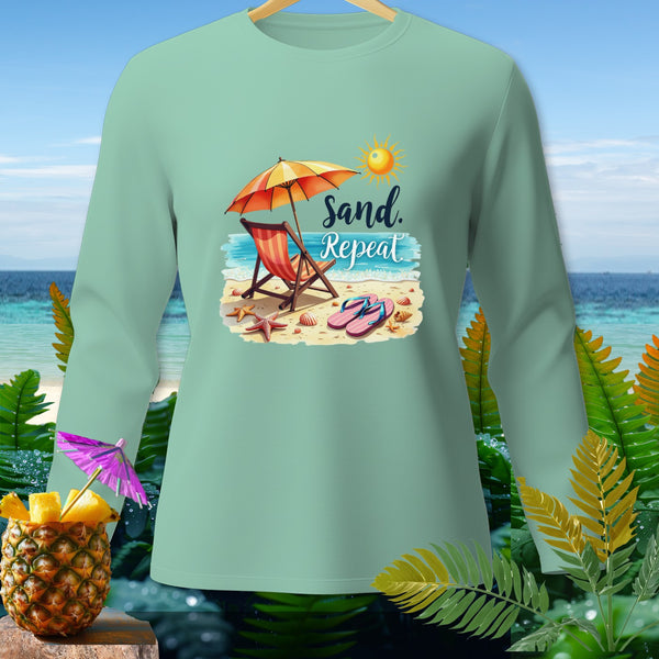 Light green long-sleeve shirt with "Sand. Repeat." beach graphic.