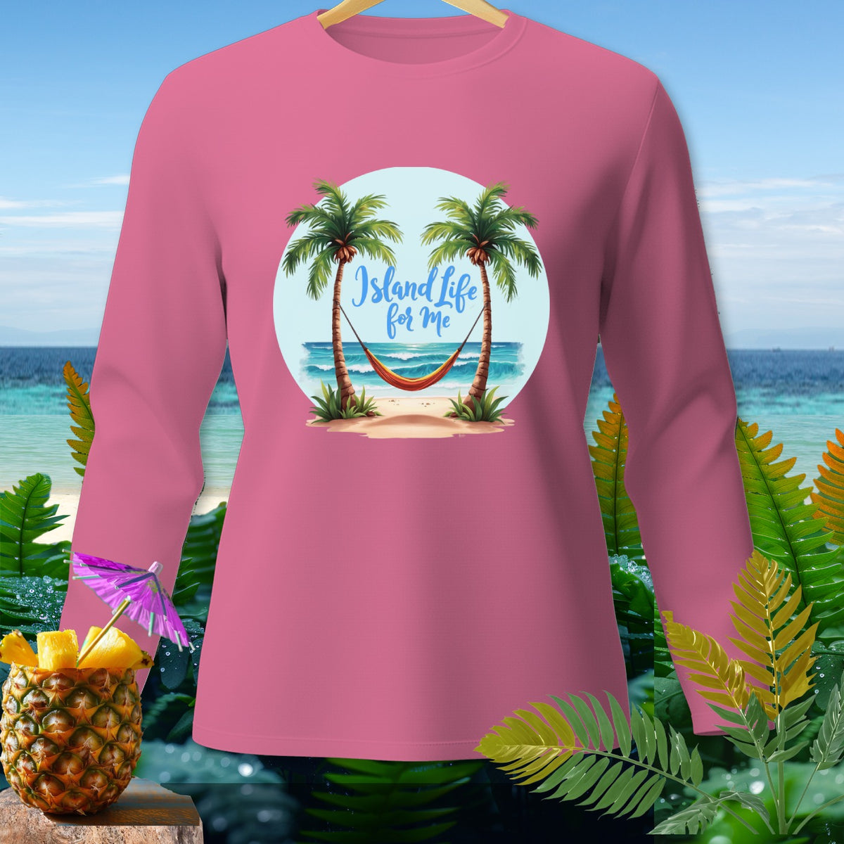 Pink long-sleeve shirt with a graphic of palm trees, hammock, and the text "Island Life for Me".