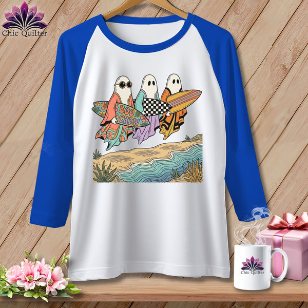 Three ghosts carry surfboards on a beach with "Boo Crew" text.