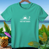 Teal t-shirt with white sunset, waves, palm tree graphic and 