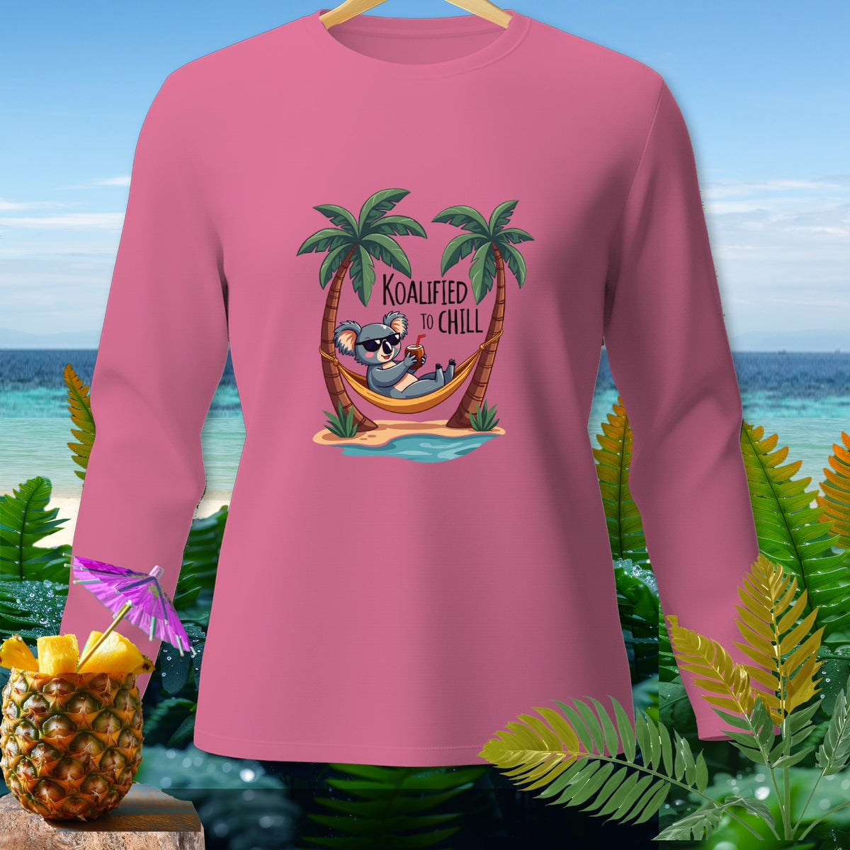 Pink long-sleeved shirt with a koala in a hammock and text "Koalified to Chill".