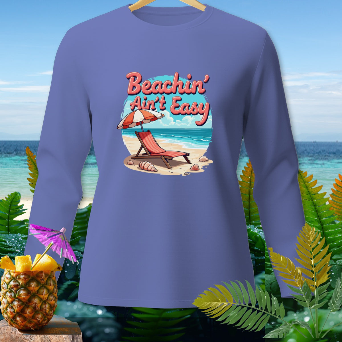 Purple long-sleeve shirt with a beach scene and "Beachin' Ain't Easy" text.