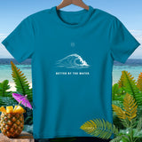 Teal t-shirt with white wave graphic and text 