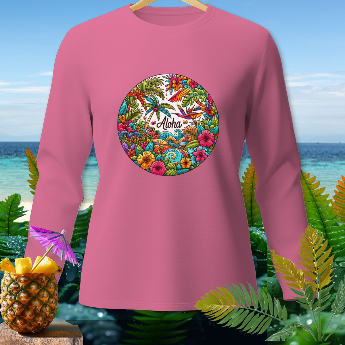 Pink long-sleeve shirt with a circular tropical "Aloha" graphic.