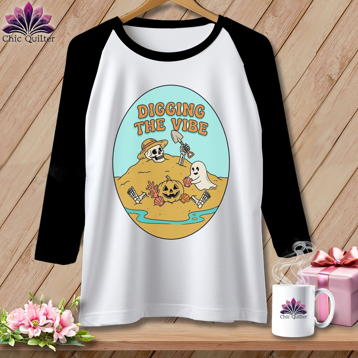 White baseball tee with graphic of skeleton, pumpkin, and ghost with text "DIGGING THE VIBE".