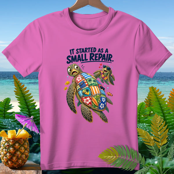 Pink t-shirt with two cartoon sea turtles, one with a patchwork shell, and text.
