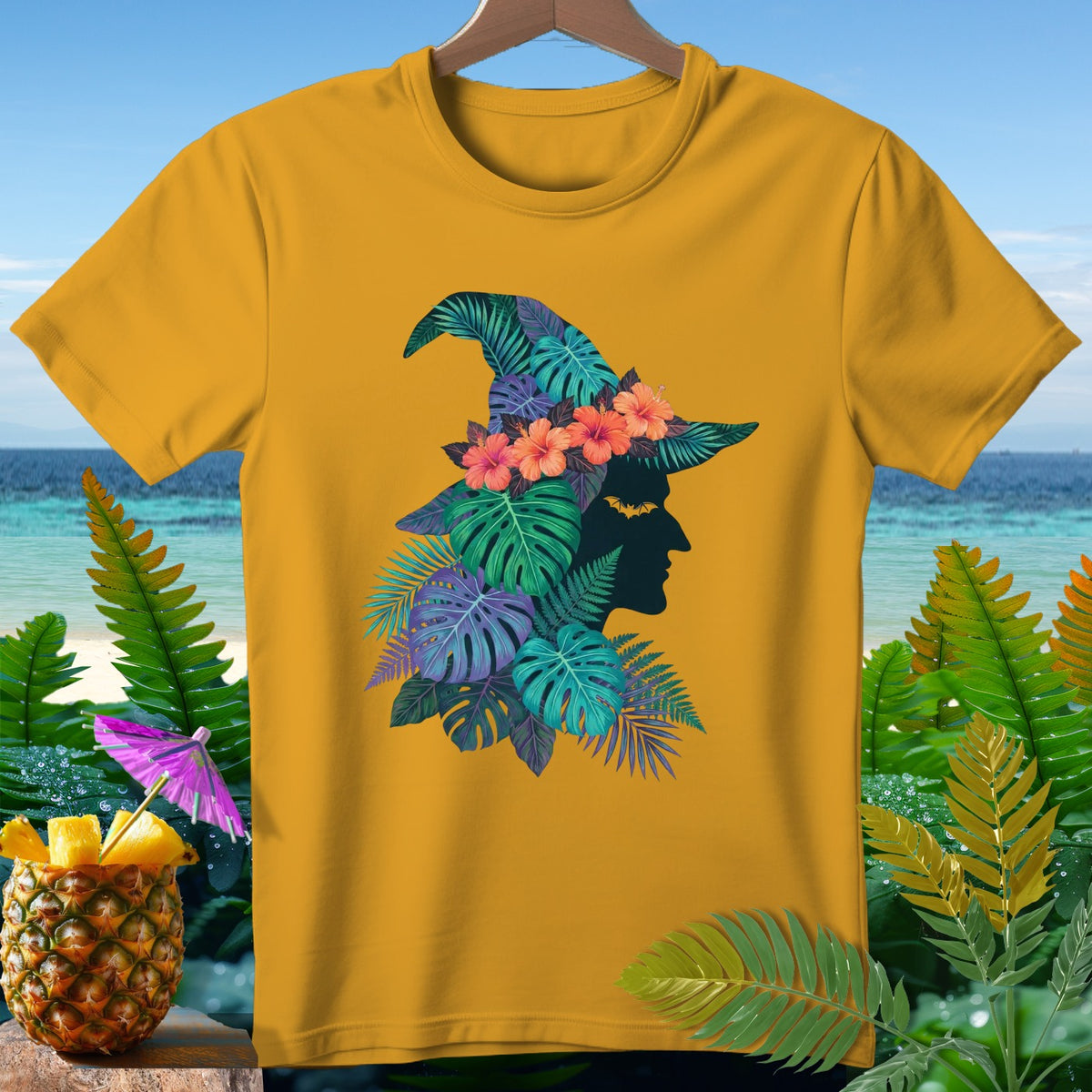 Yellow t-shirt with witch silhouette and tropical foliage design.