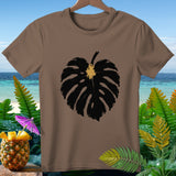 Brown t-shirt with a black monstera leaf graphic and tropical background.