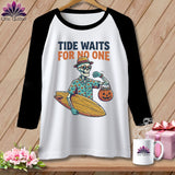 White baseball tee with skeleton holding surfboard and pumpkin bag, 