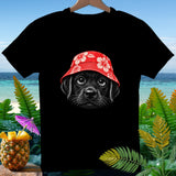 Black t-shirt with a black puppy wearing a red hibiscus bucket hat.