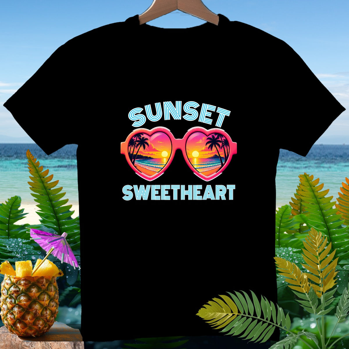 Black t-shirt with "Sunset Sweetheart" text and heart-shaped sunglasses.