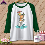 Raglan t-shirt with skeleton hand holding cocktail in waves, text 