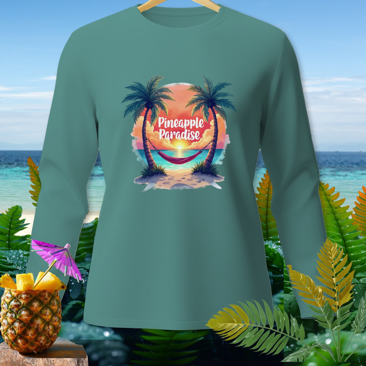 Teal long-sleeve shirt with "Pineapple Paradise" text over a beach scene.