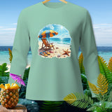 Mint green long-sleeve shirt with a beach scene graphic of an umbrella, chair, and starfish.