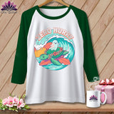 Raglan shirt with a turtle and ghost surfing a wave, text says 