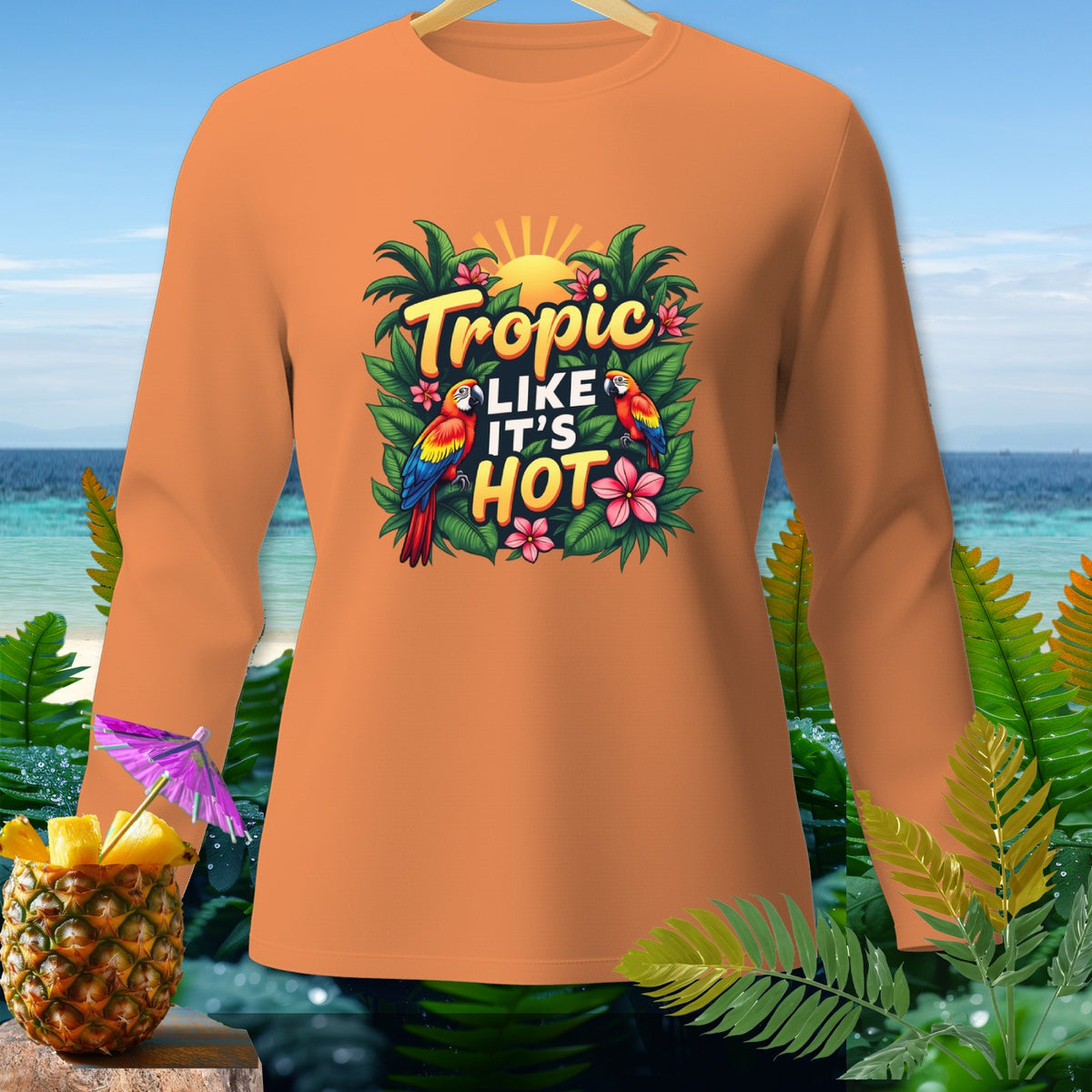 Orange long-sleeve shirt with "Tropic Like It's Hot" and parrots graphic.