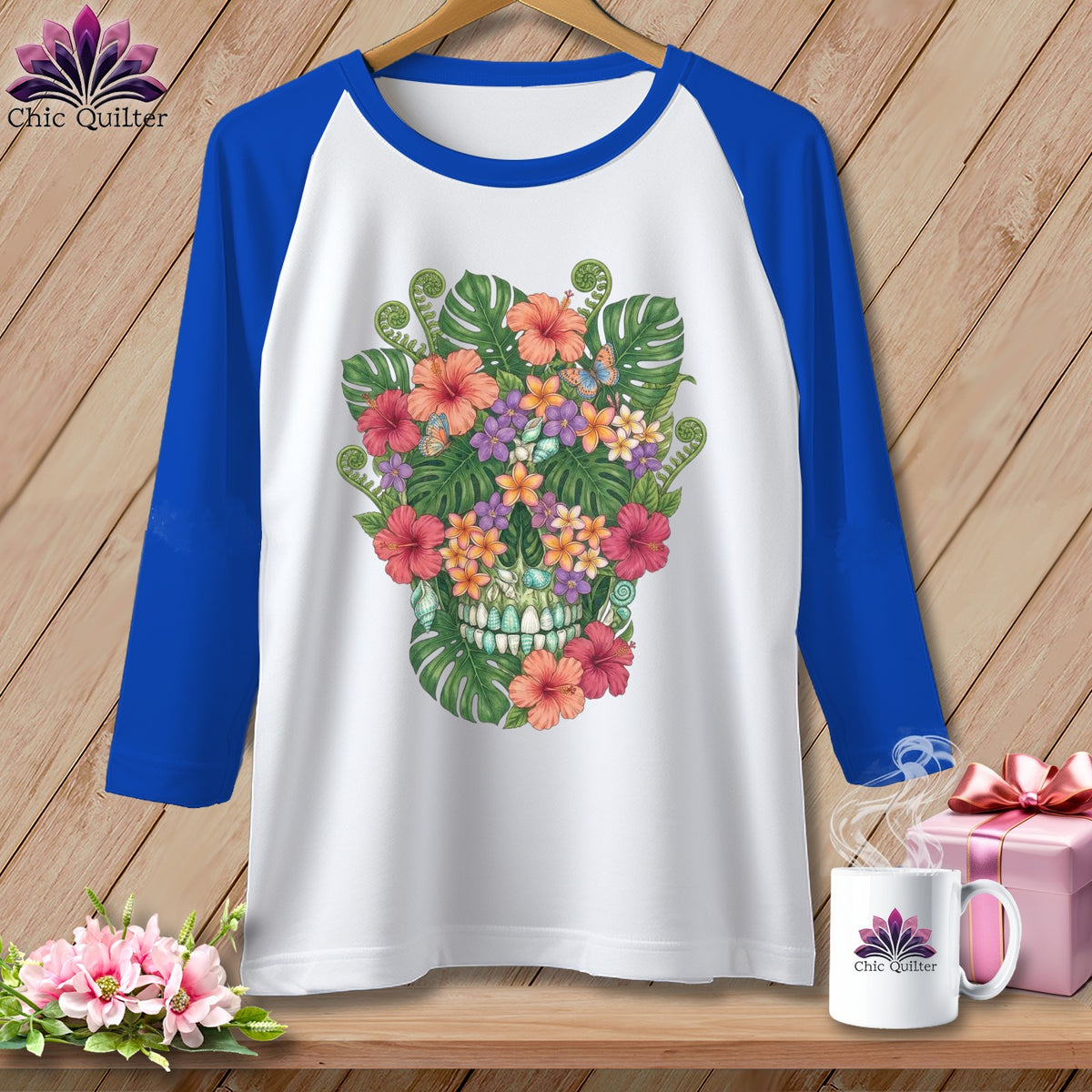 White raglan t-shirt with blue sleeves featuring a colorful floral skull design.