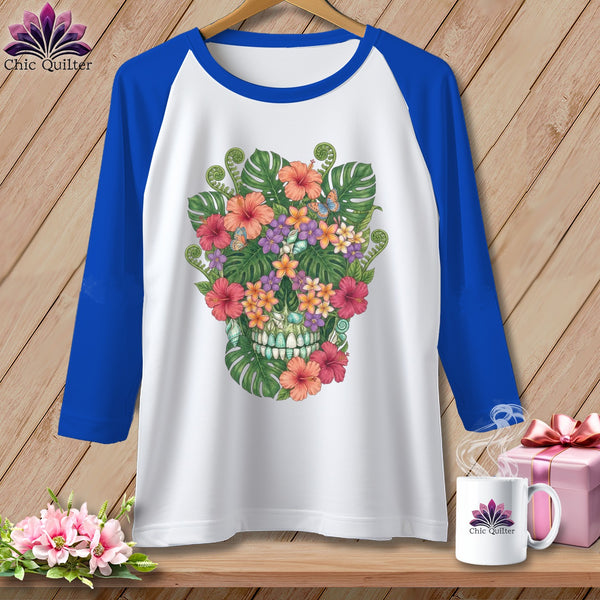 White raglan t-shirt with blue sleeves featuring a colorful floral skull design.