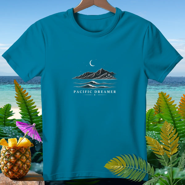 Teal t-shirt with "Pacific Dreamer" text and island mountain landscape design.