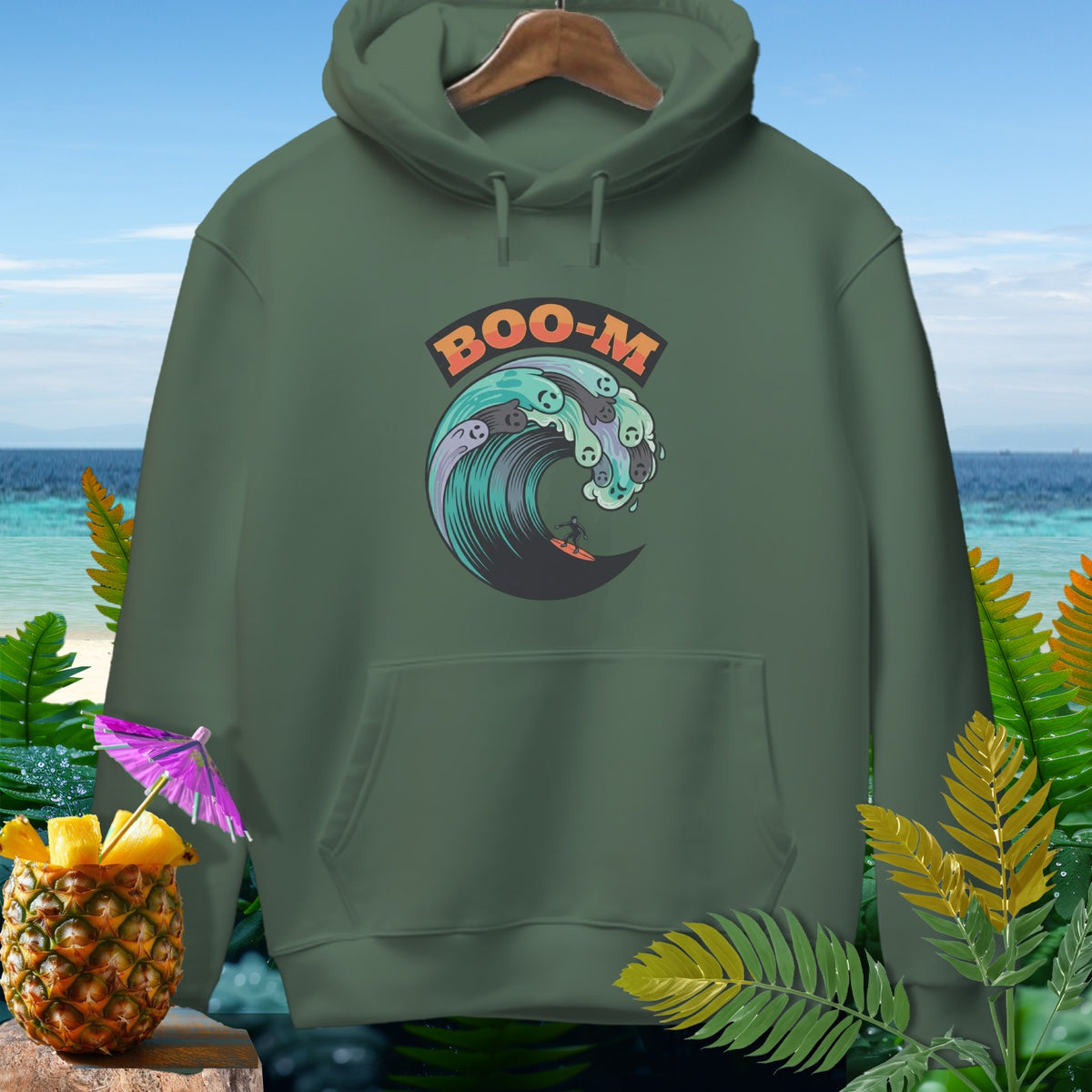 Olive green hoodie with "BOO-M" text and a surfer riding a wave with ghost-like designs.