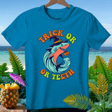 Blue t-shirt with a shark wearing a witch hat and pumpkin, text 