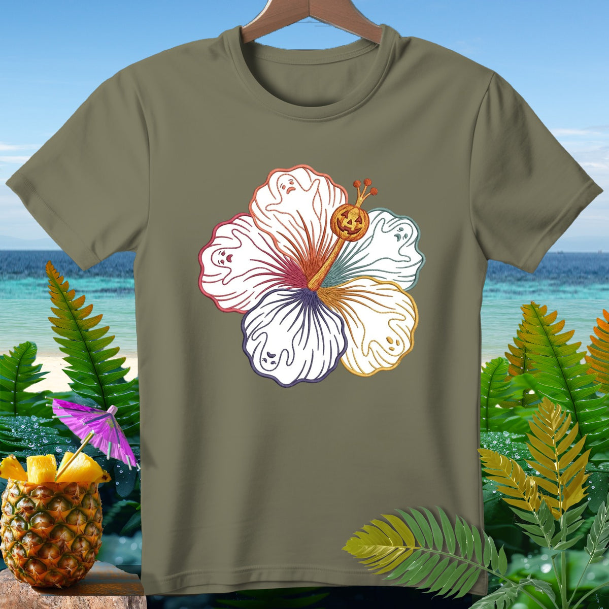Olive green t-shirt with white hibiscus flower design featuring ghost faces and a jack-o-lantern.