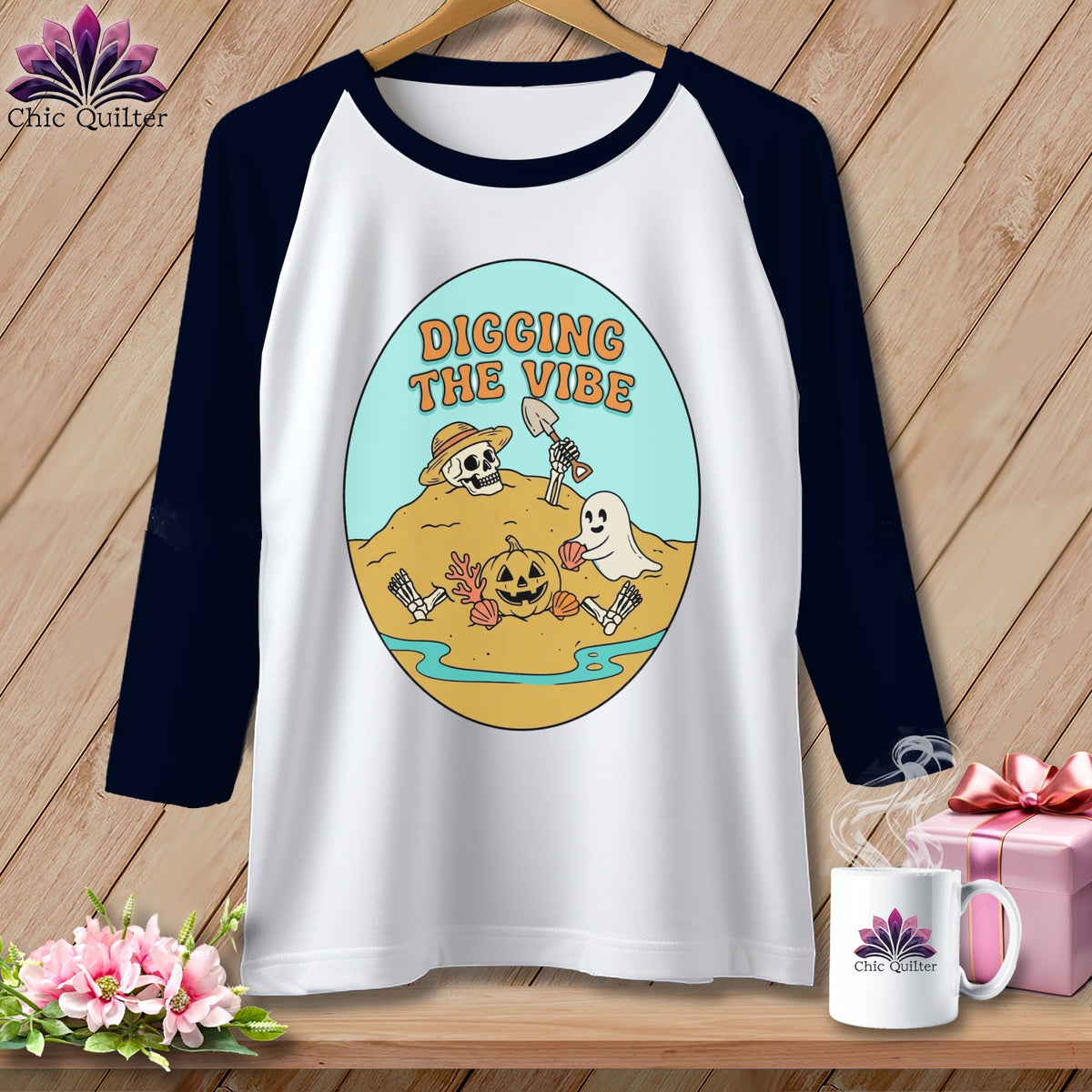 White baseball tee with Halloween graphic of skeleton, ghost, pumpkin, and text "Digging the Vibe".