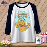 White baseball tee with Halloween graphic of skeleton, ghost, pumpkin, and text 