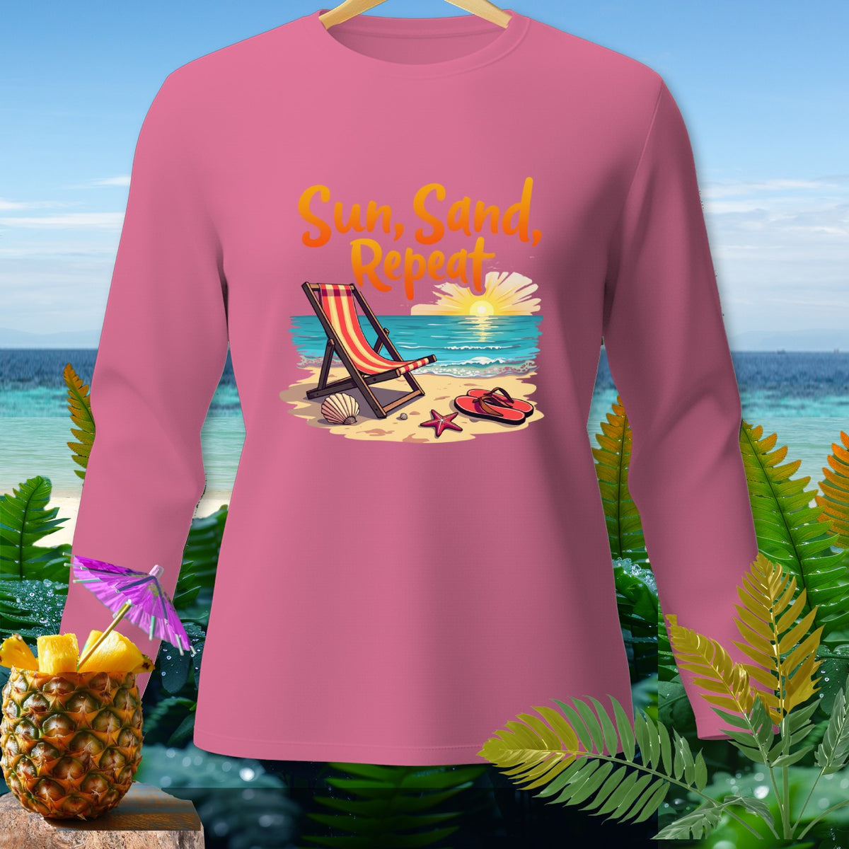 Pink long-sleeve shirt with "Sun, Sand, Repeat" beach graphic.