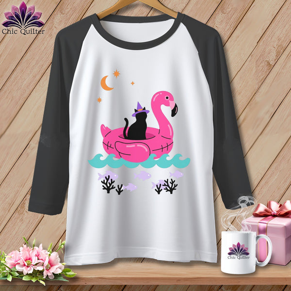 Black cat in witch hat on pink flamingo float with crescent moon and fish.