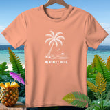 Peach t-shirt with white palm tree, ocean, and sun graphic and text.