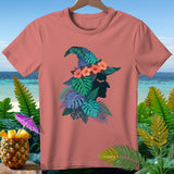 Coral t-shirt with tropical witch hat design featuring flowers and leaves.
