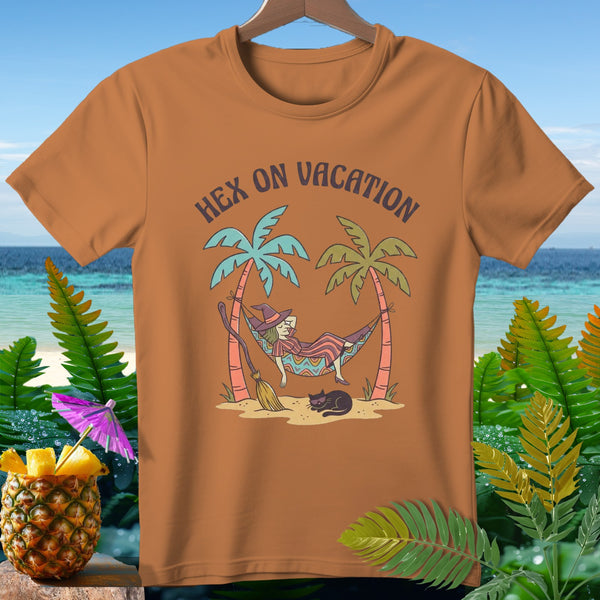 Orange t-shirt with witch and cat relaxing on beach with "Hex on Vacation" text.