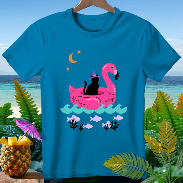 Turquoise t-shirt with black cat on pink flamingo float, crescent moon, stars, and fish.