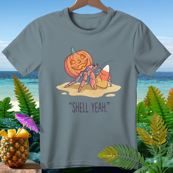 Hermit crab wearing pumpkin shell, holding candy corn, with text "SHELL YEAH."