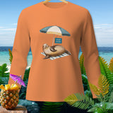Orange long-sleeve shirt with a seal on a beach towel under an umbrella that reads 