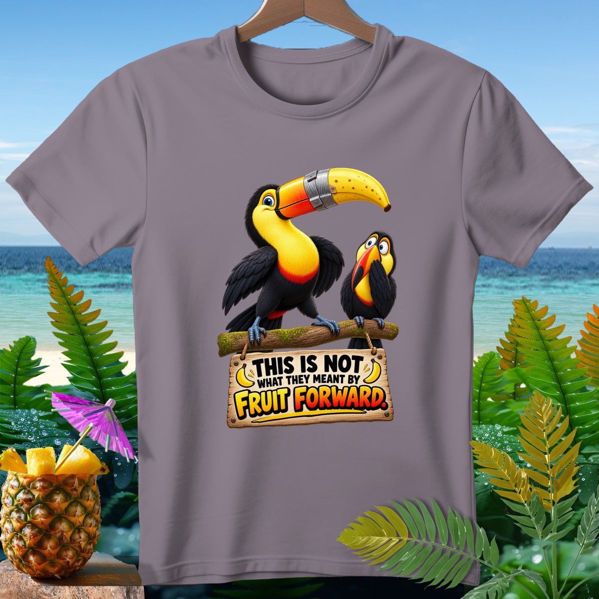 Two toucans on a branch with a sign that reads "This is not what they meant by fruit forward."