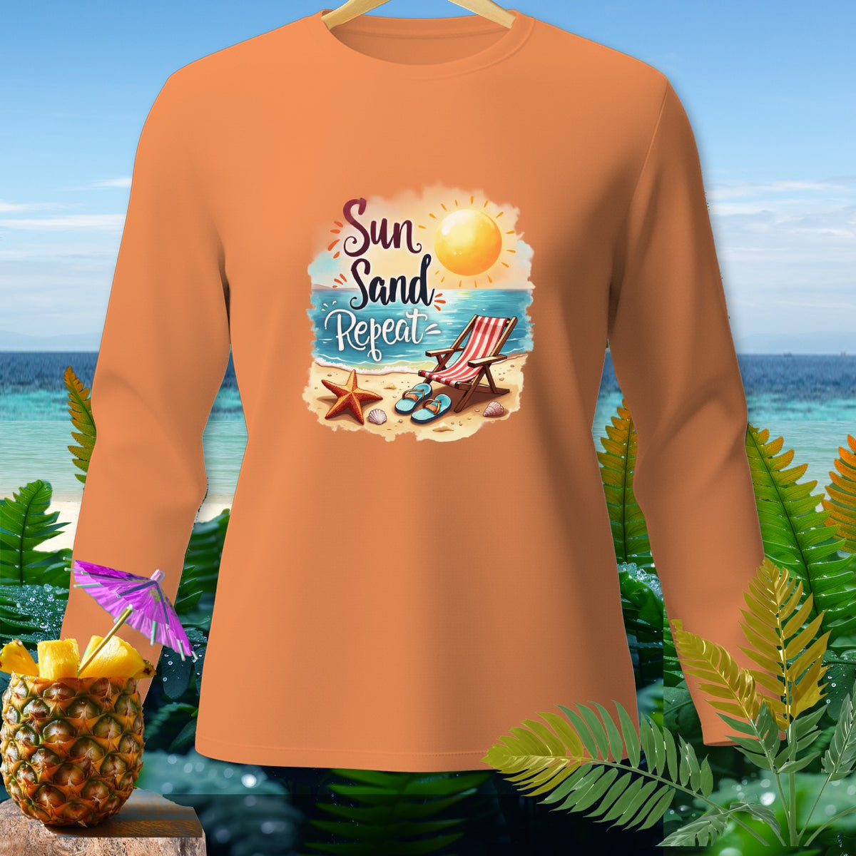 Orange long-sleeve shirt with "Sun Sand Repeat" beach graphic and pineapple drink.