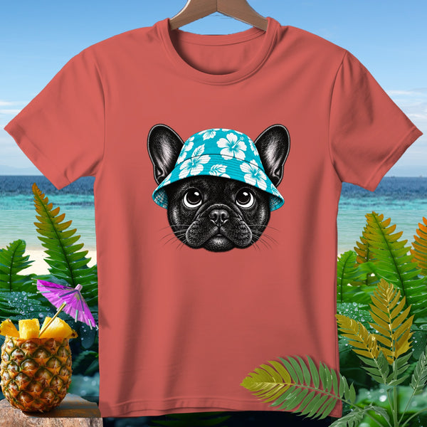 Coral t-shirt with black French bulldog wearing blue floral hat, beach background.