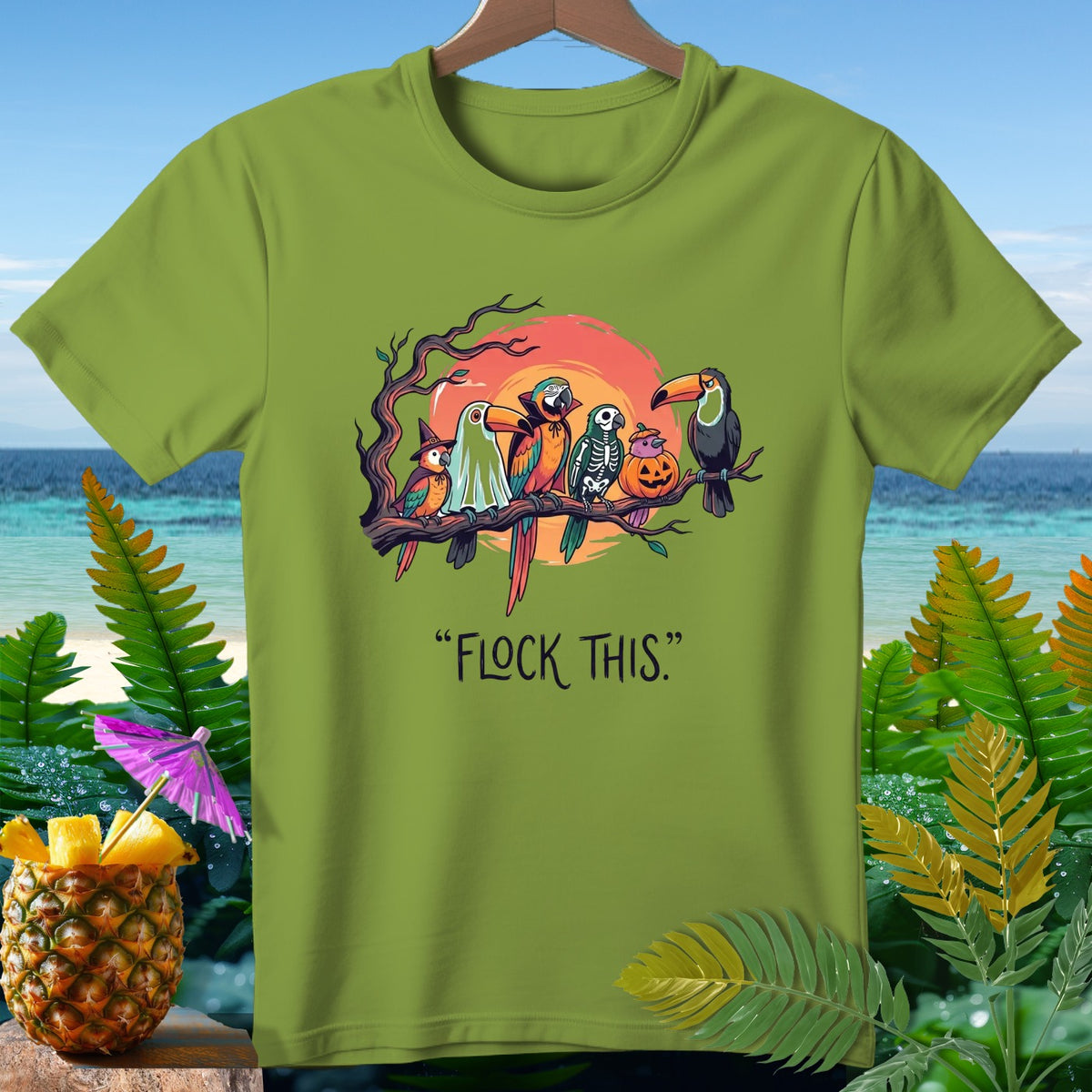 Parrots and toucan dressed for Halloween on a branch with text "FLOCK THIS."